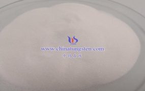 What Does Ammonium Metatungstate React to Under Alkaline Conditions?